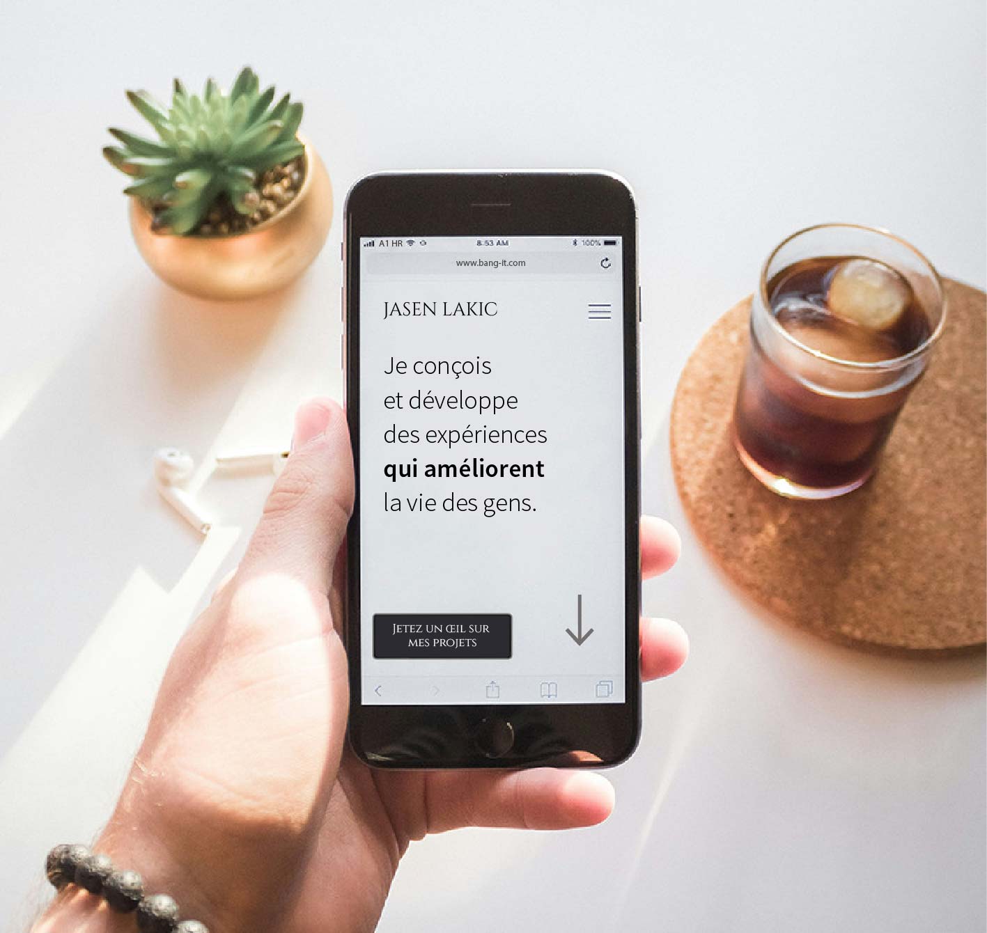 image portraying a table with a plant and a hand holding mobile phone, on mobile phone we see company pitch